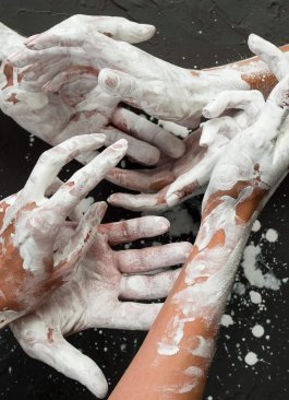 top-view-hands-covered-white-paint